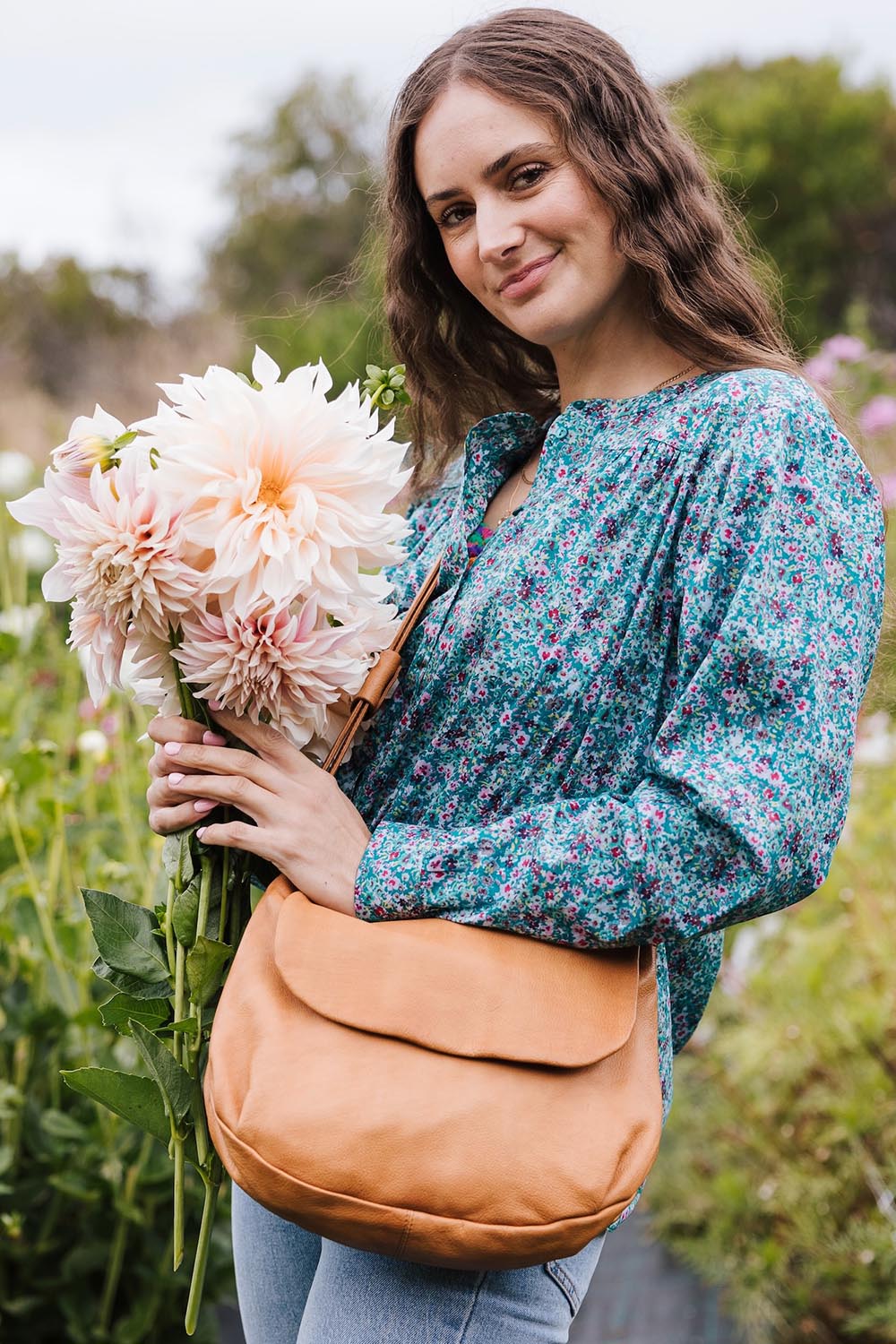 A model wearing the Grace Leather Bag in colour Tan, from the front, showing the whole outfit