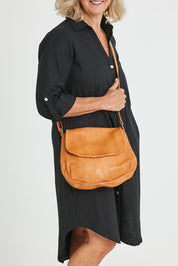 Model Sandy wearing size OneSize of the Grace Leather Bag in colour Tan, from the front, cropped image