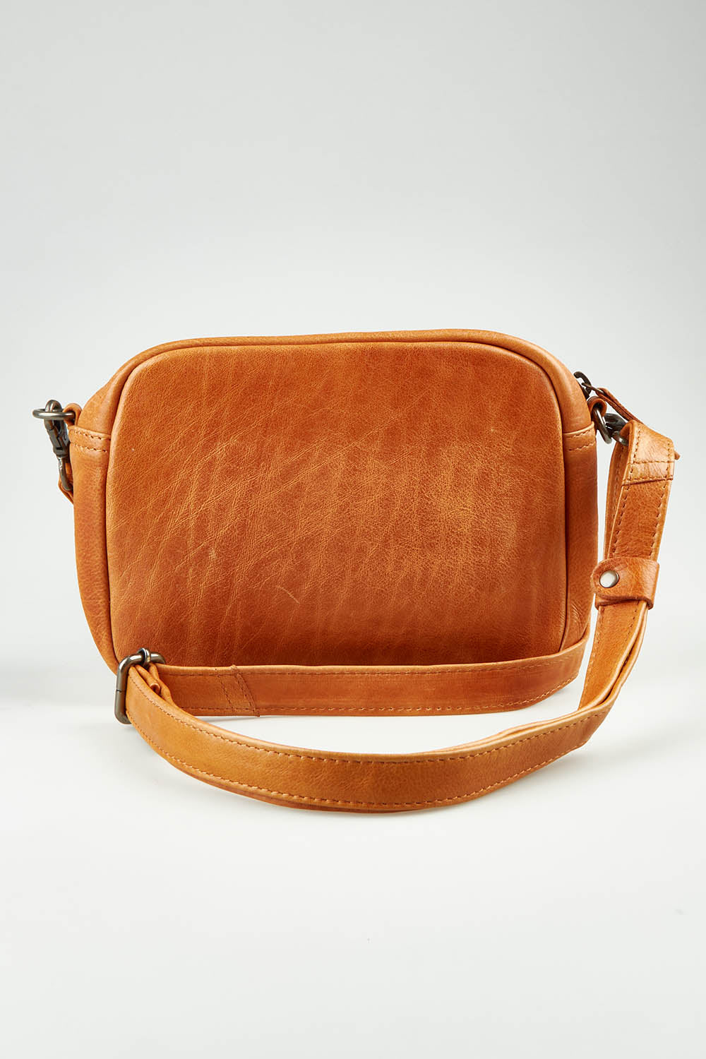 A model wearing size OneSize of the Head In The Clouds Leather Bag in colour Tan, from the front, showing the whole outfit