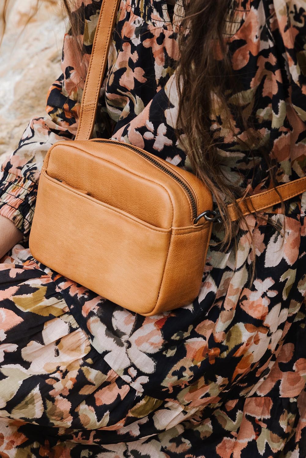 A model wearing the Head In The Clouds Leather Bag in colour Tan, from the front, showing the whole outfit