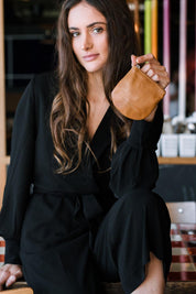 A model wearing the Lilly Leather Coin Purse in colour Tan, from the front, showing the whole outfit