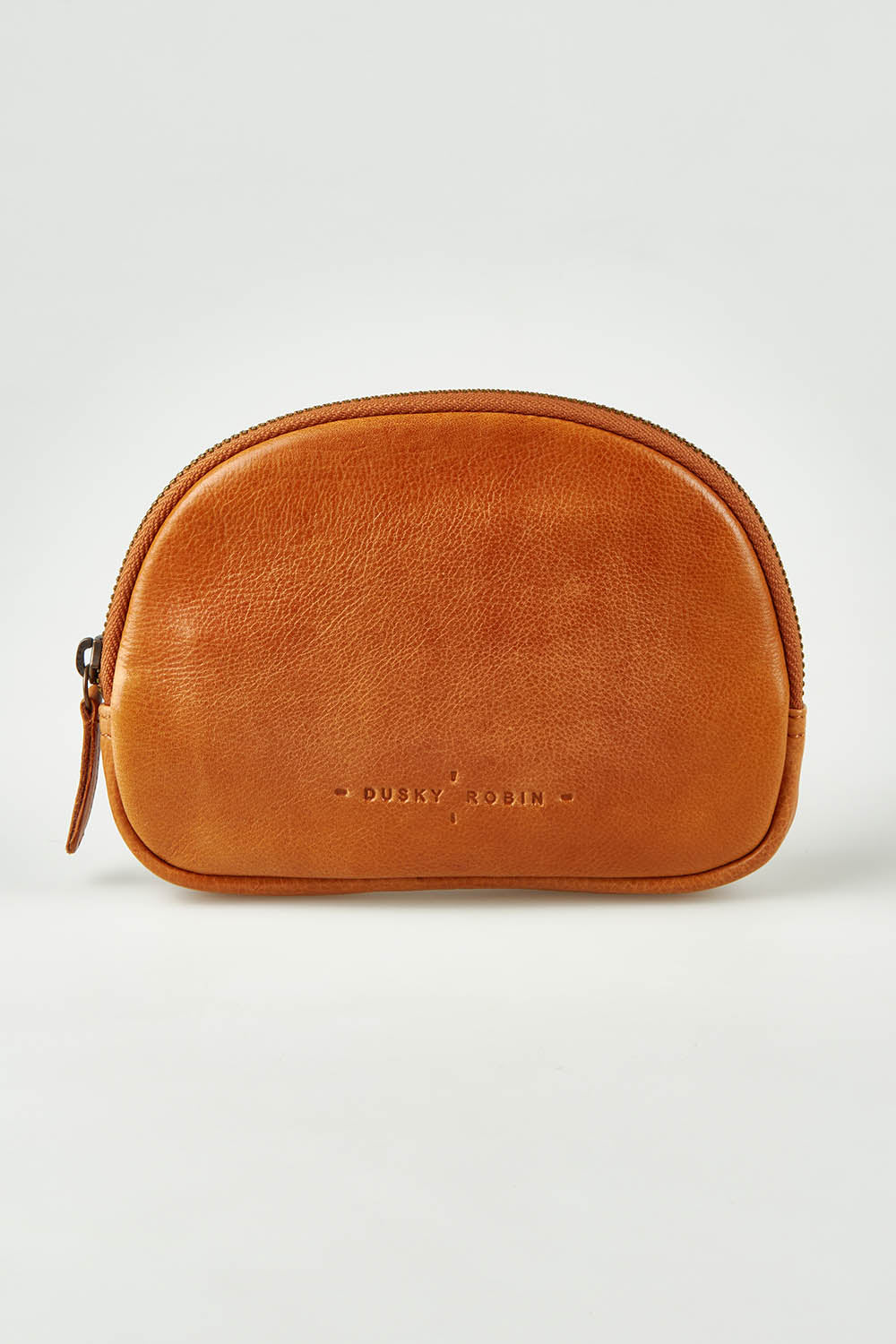 A model wearing the Romi Leather Clutch in colour Tan, from the front, showing the whole outfit