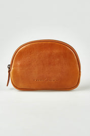 A model wearing the Romi Leather Clutch in colour Tan, from the front, showing the whole outfit