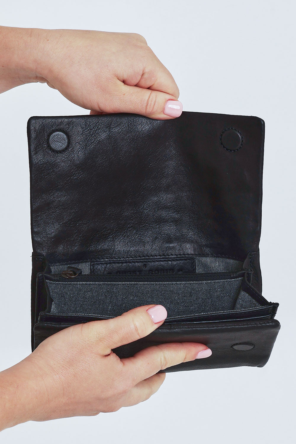 Model Steph wearing size OneSize of the Rose Leather Purse in colour Black (Black), from the front, cropped image