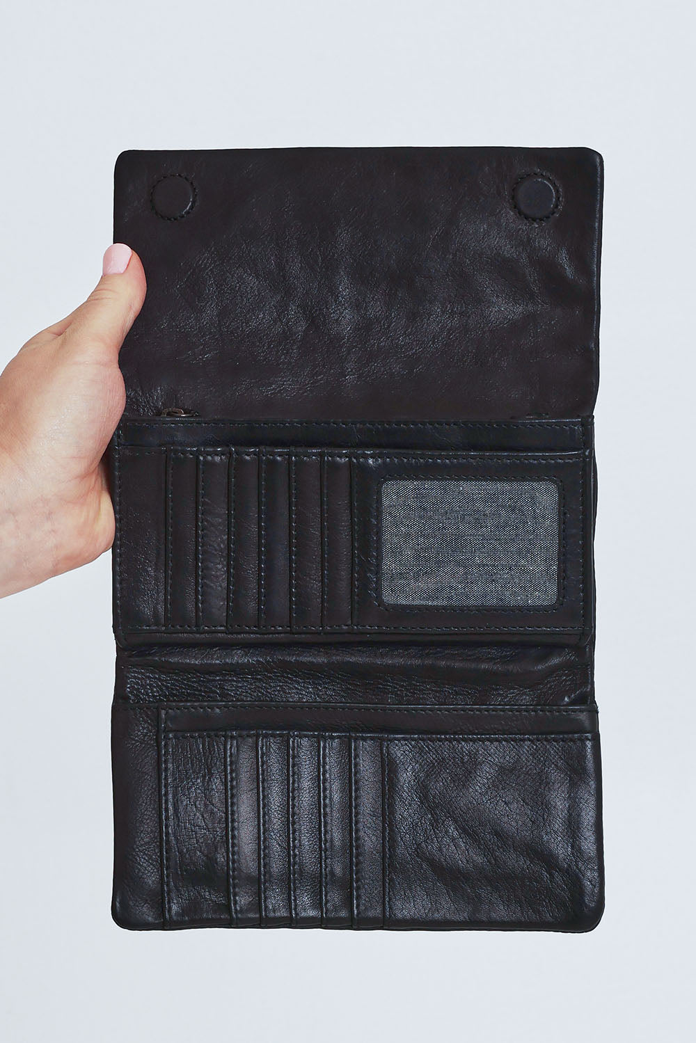 Model Steph wearing size OneSize of the Rose Leather Purse in colour Black (Black), from the front, cropped image