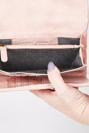 A model wearing size OneSize of the Rose Leather Purse in colour Duskypink (Pink), from the front, showing the whole outfit