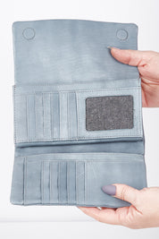 A model wearing size OneSize of the Rose Leather Purse in colour Steelgrey (Grey), from the front, showing the whole outfit