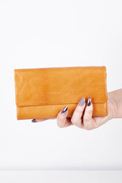 A model wearing size OneSize of the Rose Leather Purse in colour Tan, from the front, showing the whole outfit