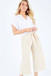Model Hayley wearing size S of the Manyara Culotte in colour Clay, from the front, cropped image