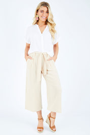 Model Hayley wearing size S of the Manyara Culotte in colour Clay, from the front, showing the whole outfit