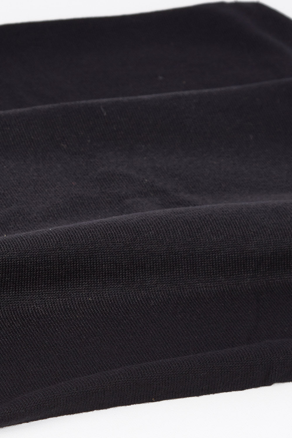 A model wearing size OneSize of the Astor Snood in colour Raven (Black), from the front, showing the whole outfit