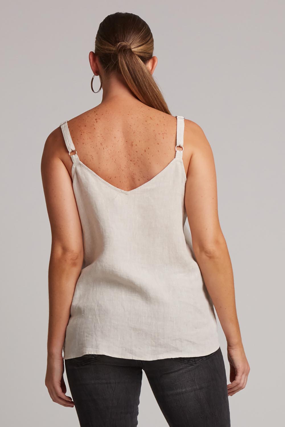 A model wearing the Studio Linen Tank in colour Tusk, from the back