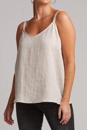 A model wearing the Studio Linen Tank in colour Tusk, from the front, cropped image