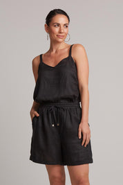 A model wearing the Studio Linen Short in colour Ebony (Black), from the front, cropped image