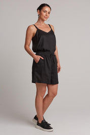 A model wearing the Studio Linen Short in colour Ebony (Black), from the front, showing the whole outfit