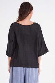 Model Madeline wearing size OneSize of the Studio Relaxed Top in colour Ebony (Black), from the back