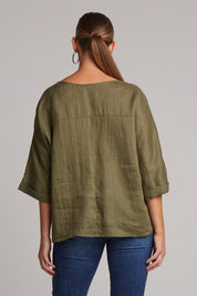 A model wearing the Studio Relaxed Top in colour Khaki (Green), from the back