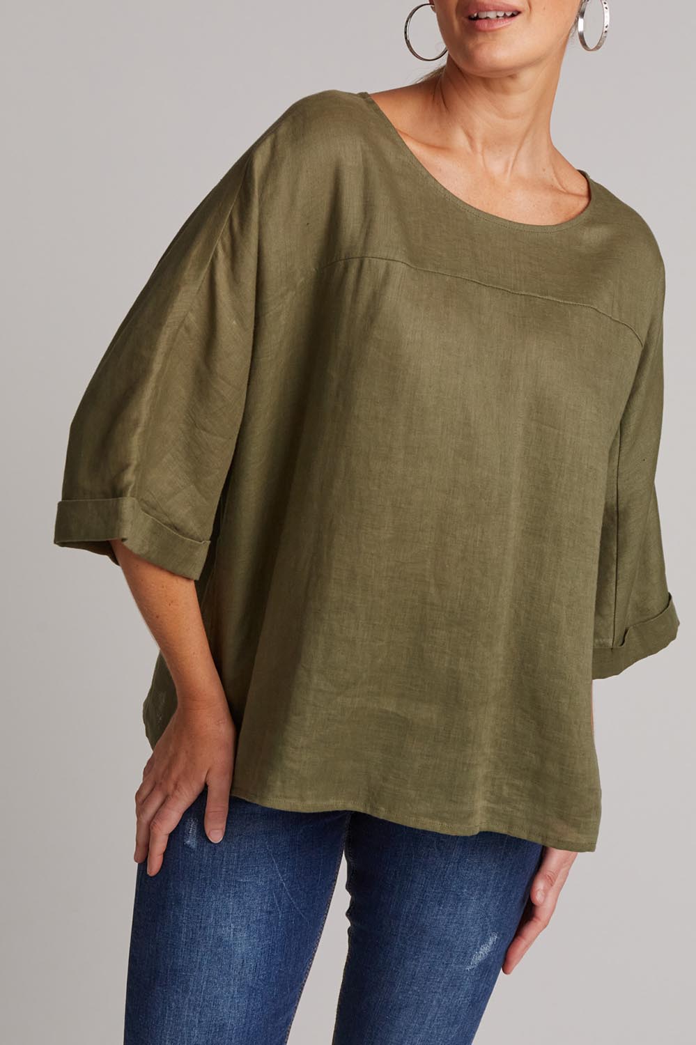 A model wearing the Studio Relaxed Top in colour Khaki (Green), from the front, cropped image