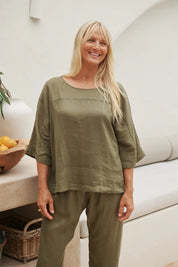 A model wearing the Studio Relaxed Top in colour Khaki (Green), from the front, showing the whole outfit