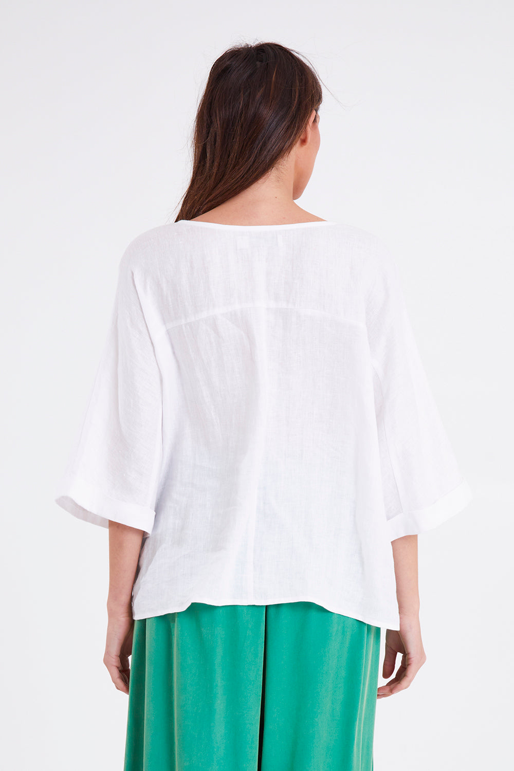 Model Madeline wearing size OneSize of the Studio Relaxed Top in colour Salt (White), from the back