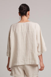A model wearing the Studio Relaxed Top in colour Tusk, from the back