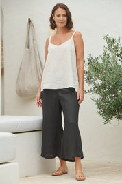 A model wearing the Studio Crop Pant in colour Ebony (Black), from the front, showing the whole outfit