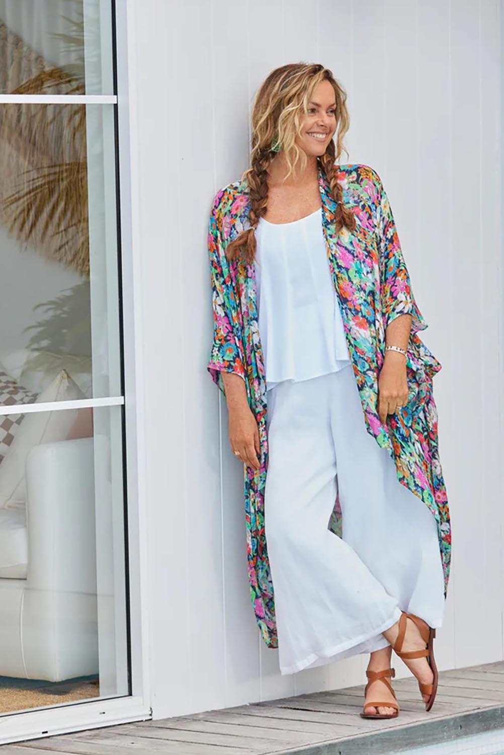 A model wearing the Studio Crop Pant in colour Salt (White), from the front, showing the whole outfit