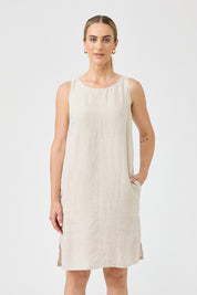A model wearing the Studio Linen Midi Dress in colour Tusk, from the front, cropped image