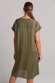 A model wearing the Studio Linen Dress in colour Khaki (Green), from the back