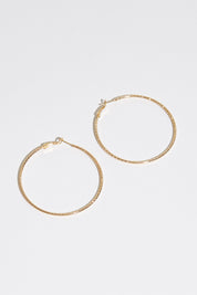 A model wearing size OneSize of the Fleur Hoop Earring in colour Gold (Metallics), from the front, showing the whole outfit