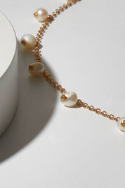 A model wearing size OneSize of the Belladonna Pearl Drop Necklace in colour Pearldrop (Metallics), from the front, showing the whole outfit