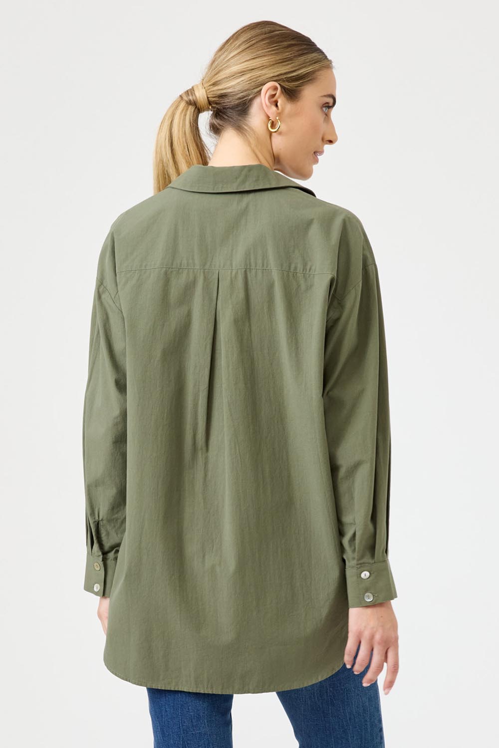 A model wearing the Studio Oversize Cotton Shirt in colour Khaki (Green), from the back