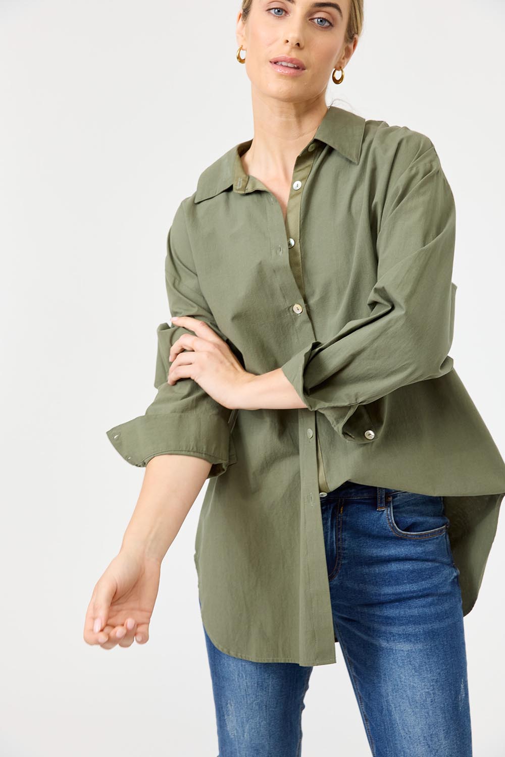 A model wearing the Studio Oversize Cotton Shirt in colour Khaki (Green), from the front, cropped image