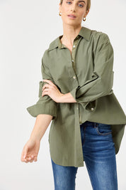 A model wearing the Studio Oversize Cotton Shirt in colour Khaki (Green), from the front, cropped image