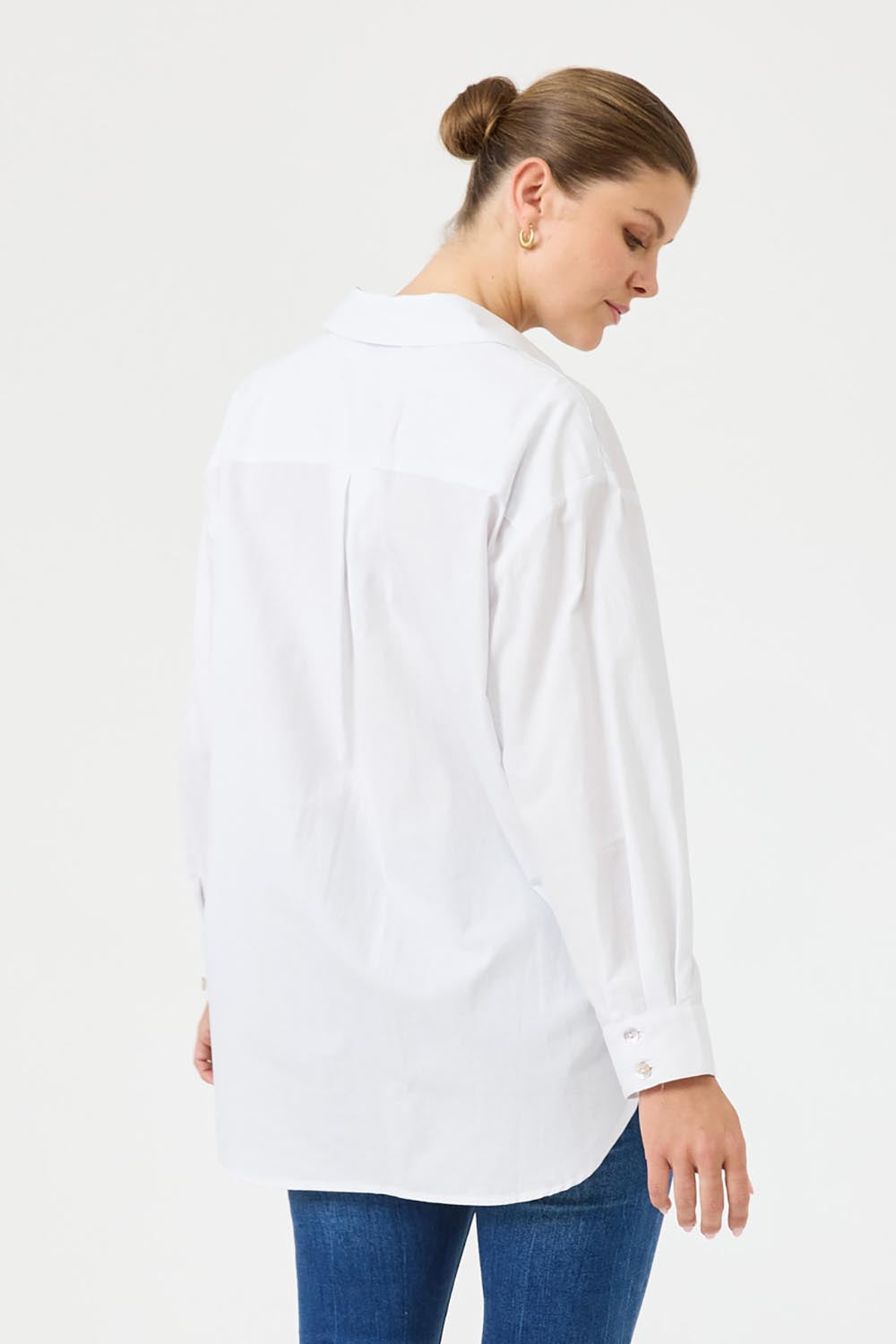 A model wearing the Studio Oversize Cotton Shirt in colour Salt (White), from the back