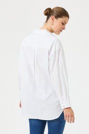 A model wearing the Studio Oversize Cotton Shirt in colour Salt (White), from the back