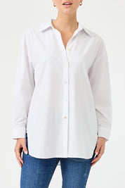 A model wearing the Studio Oversize Cotton Shirt in colour Salt (White), from the front, cropped image