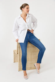 A model wearing the Studio Oversize Cotton Shirt in colour Salt (White), from the front, showing the whole outfit
