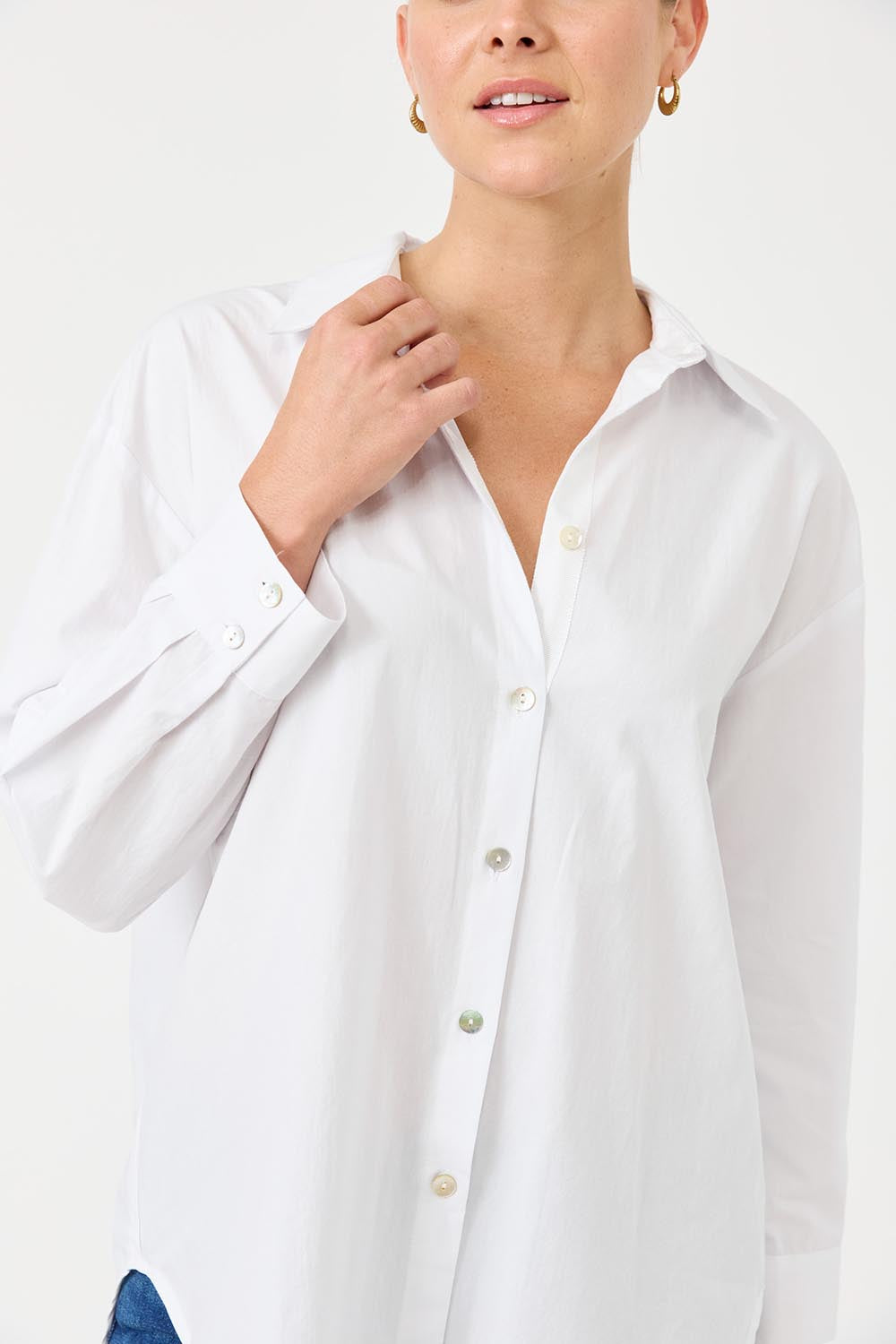 A model wearing the Studio Oversize Cotton Shirt in colour Salt (White), from the front, showing the whole outfit