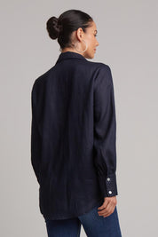 A model wearing the Studio Linen Shirt in colour Navy (Blue), from the back