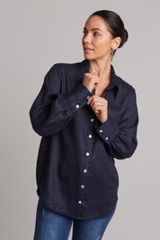 A model wearing the Studio Linen Shirt in colour Navy (Blue), from the front, cropped image