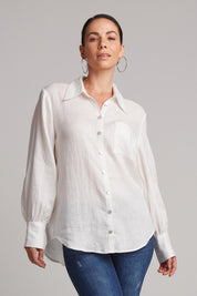 A model wearing the Studio Linen Shirt in colour Salt (White), from the front, cropped image