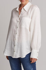 A model wearing the Studio Linen Shirt in colour Salt (White), from the front, cropped image