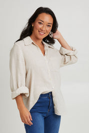 Model Katie wearing size S of the Studio Linen Shirt in colour Tusk, from the front, cropped image