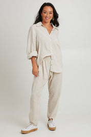 Model Katie wearing size S of the Studio Linen Shirt in colour Tusk, from the front, showing the whole outfit