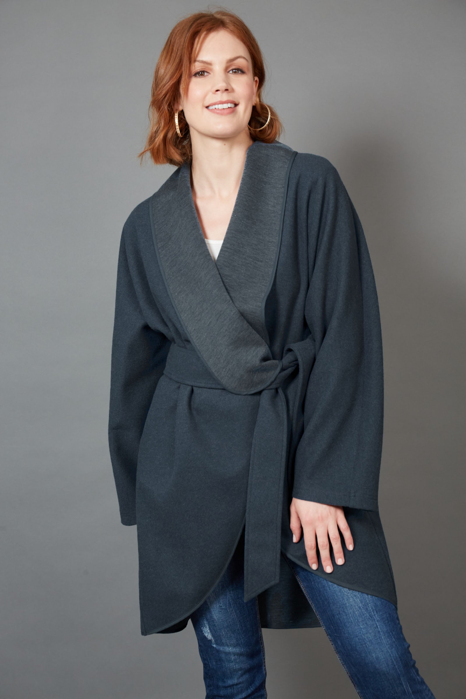 A model wearing the Klein Wrap Jacket in colour Oxford (Blue), from the front, showing the whole outfit