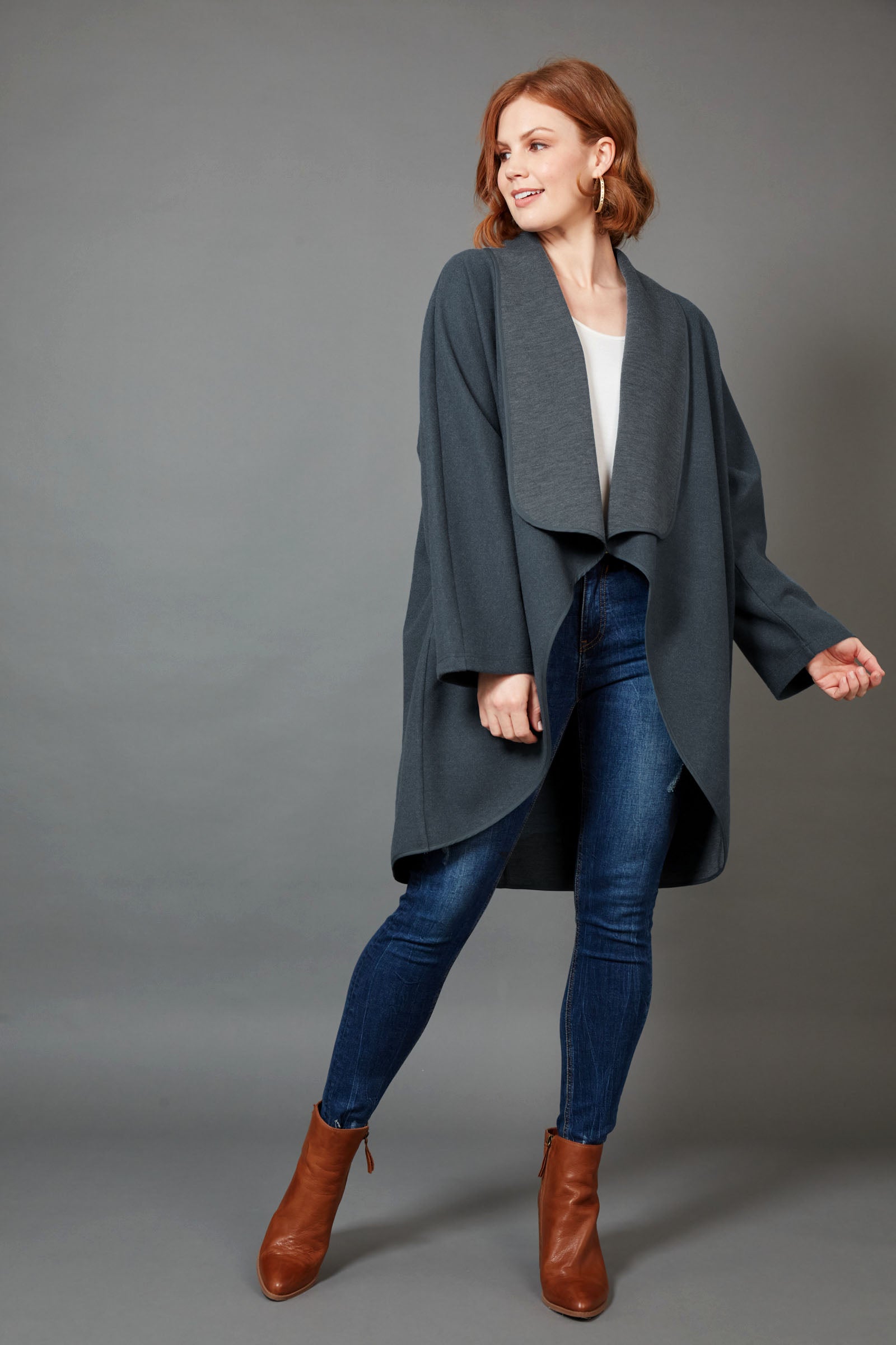 A model wearing the Klein Wrap Jacket in colour Oxford (Blue), from the front, showing the whole outfit