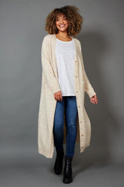 A model wearing the Kinsella Cardigan in colour Tusk, from the front, showing the whole outfit