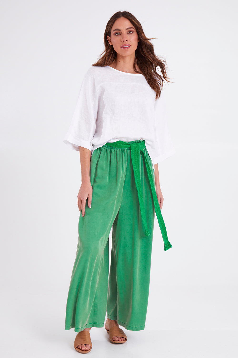 Model Madeline wearing size S of the Elan Pant in colour Meadow (Green), from the front, showing the whole outfit