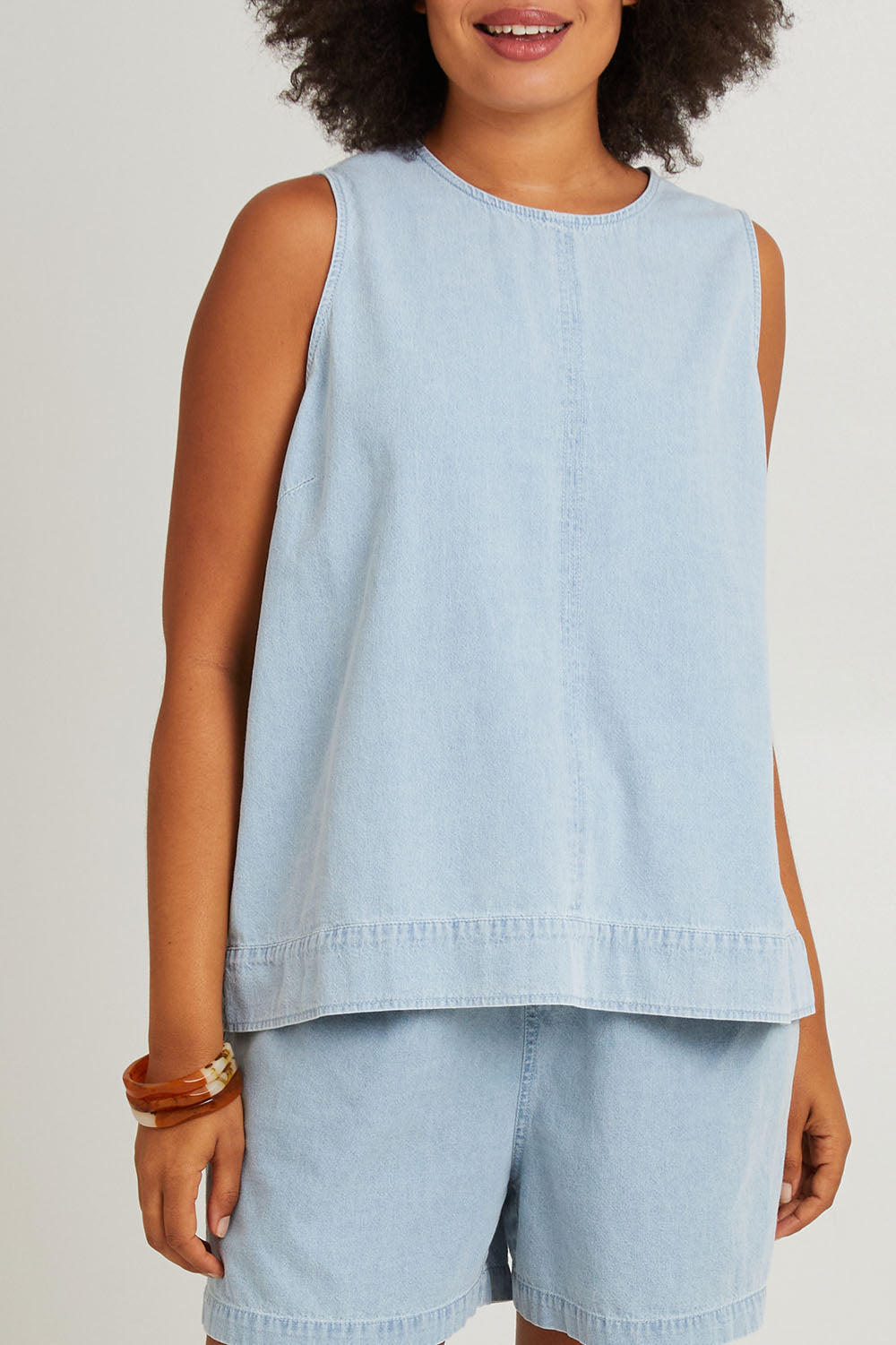 Model Olivia wearing size S of the Playa Cotton Tank in colour Capri (Blue), from the front, cropped image